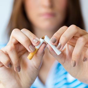 Quit-smoking-treatment-woman-breaking-a-cigarette